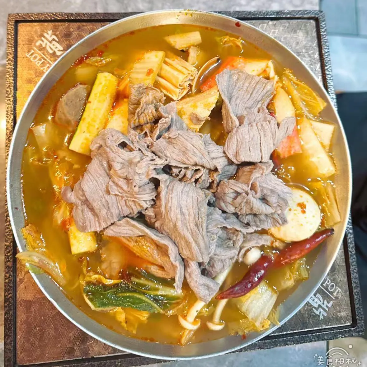Spicy beef hot pot filled with sliced beef, vegetables, tofu sticks and dried chili peppers at 100 Boil Pot & Grill, a Chinese Restaurant in Tucson