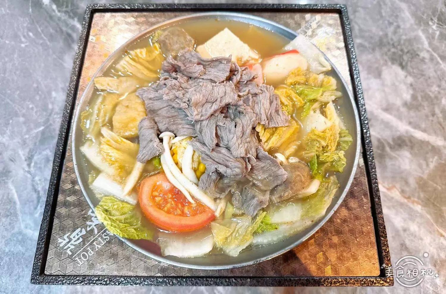 Beef hot pot loaded with sliced beef, cabbage, tomato, mushrooms and assorted fish balls at 100 Boil Pot & Grill, a Chinese Restaurant in Tucson