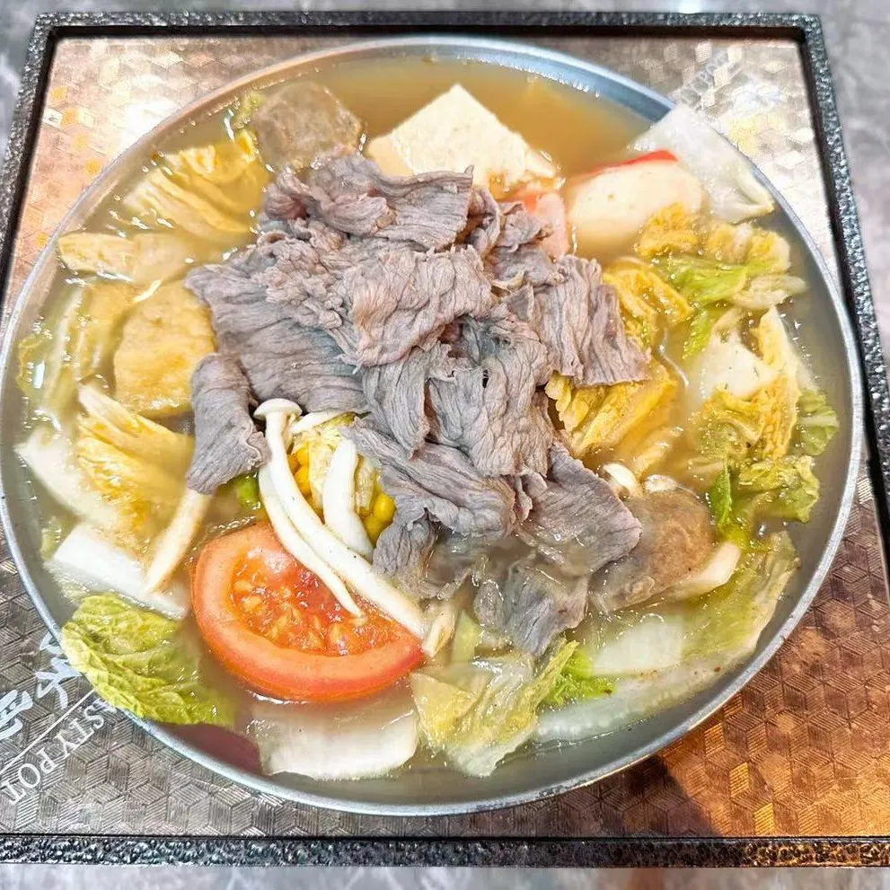 Beef hot pot loaded with sliced beef, cabbage, tomato, mushrooms and assorted fish balls at 100 Boil Pot & Grill, a Chinese Restaurant in Tucson