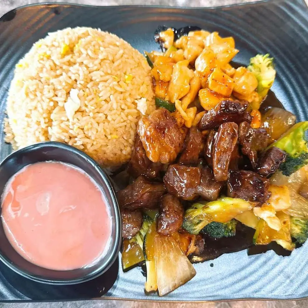 Hibachi chicken and steak combo with vegetables, fried rice and pink dipping sauce at 100 Boil Pot & Grill, a Chinese Restaurant in Tucson