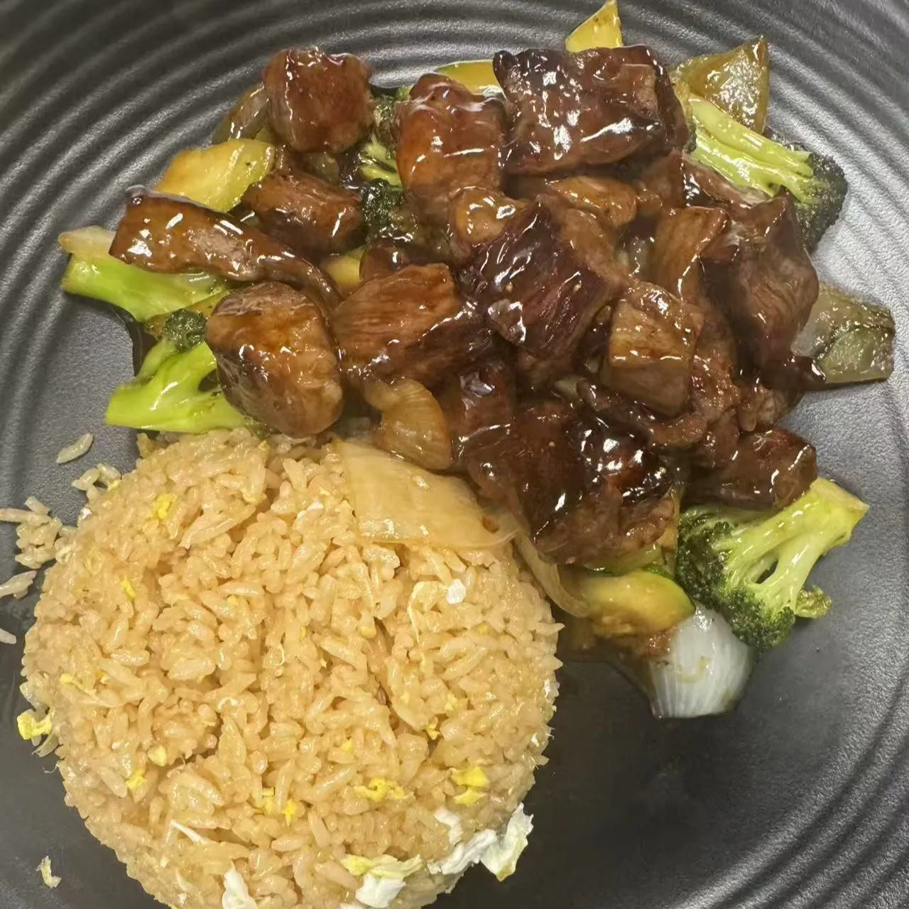 Hibachi steak cubes with broccoli, onions and a serving of egg fried rice at 100 Boil Pot & Grill, a Chinese Restaurant in Tucson
